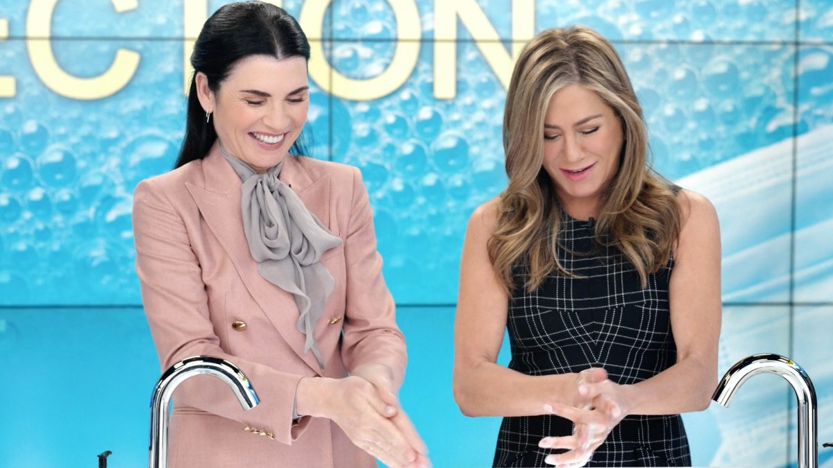 Julianna Margulies and Jennifer Aniston on The Morning Show, washing their hands.