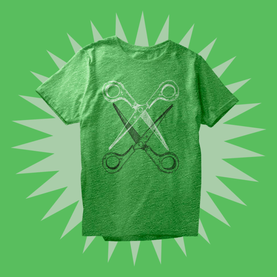 A green triblend t-shirt printed with two handdrawn pairs of scissors intersecting