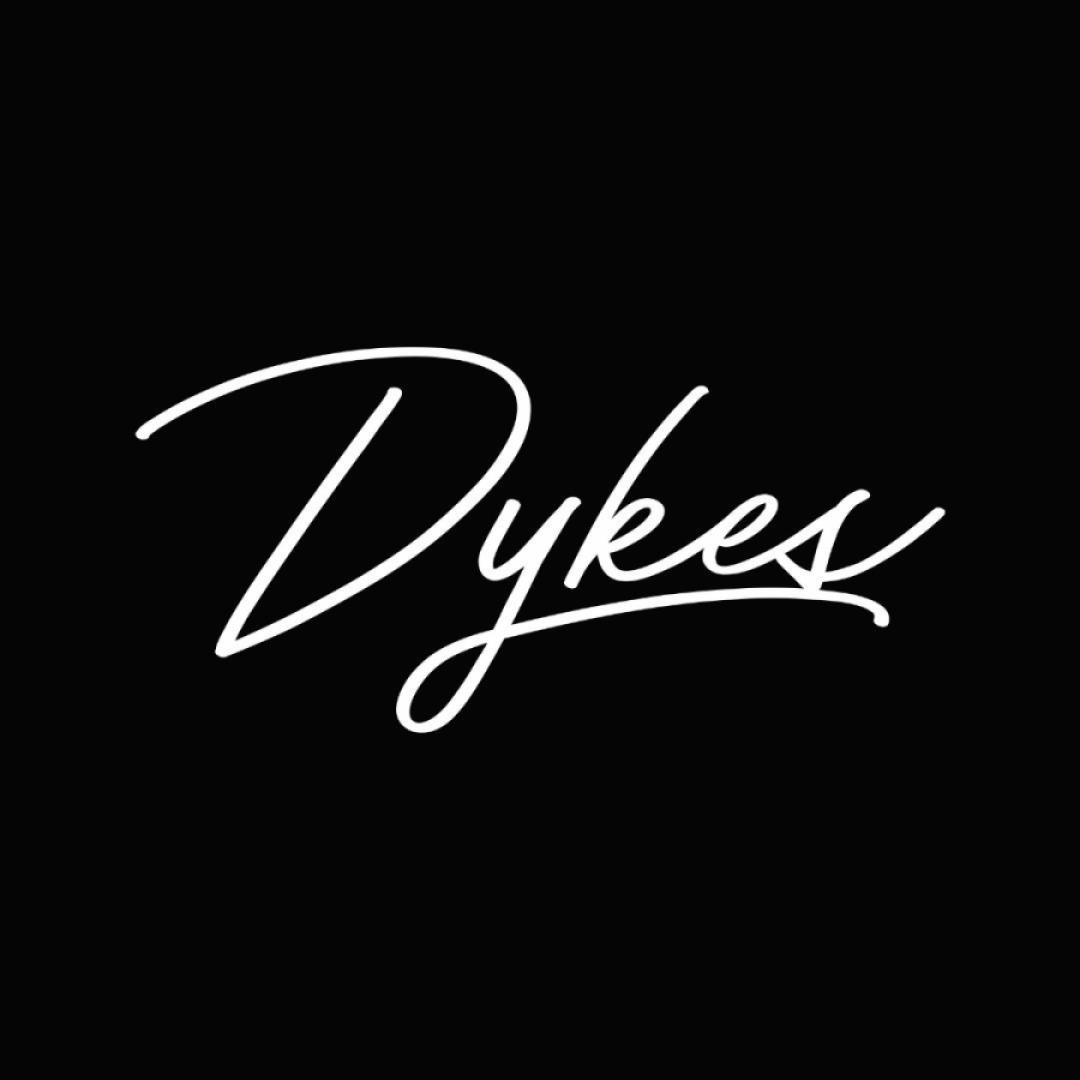 The word Dykes is written in white cursive on a black shirt.