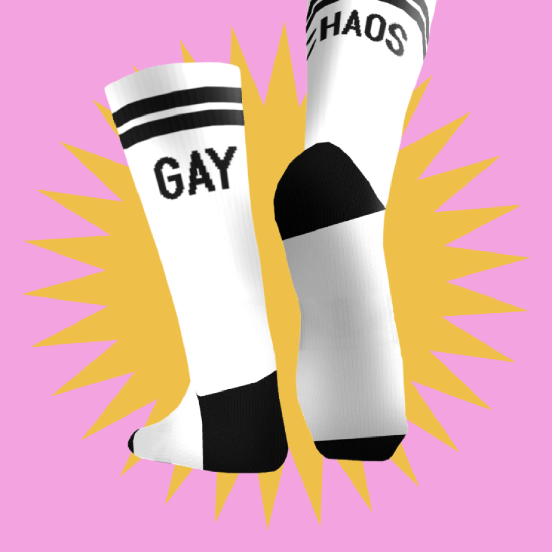 Mockup of our Gay Chaos socks - crew white socks with black stripes and the words "Gay" and "Chaos" on the back of each sock. 