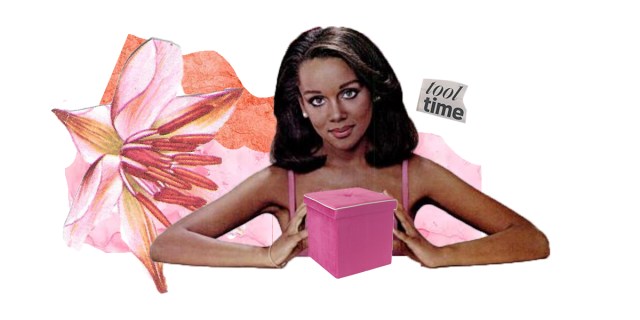 A Black woman is surrounded by a pink flower holding a pink box.