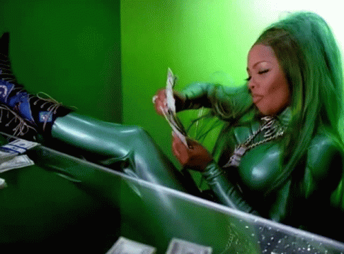 Lil Kim counts money in a gif