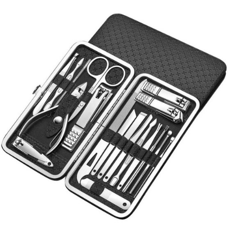 A black manicure set containing many silver tools, such as files, clippers and small scissors, is against a white background.