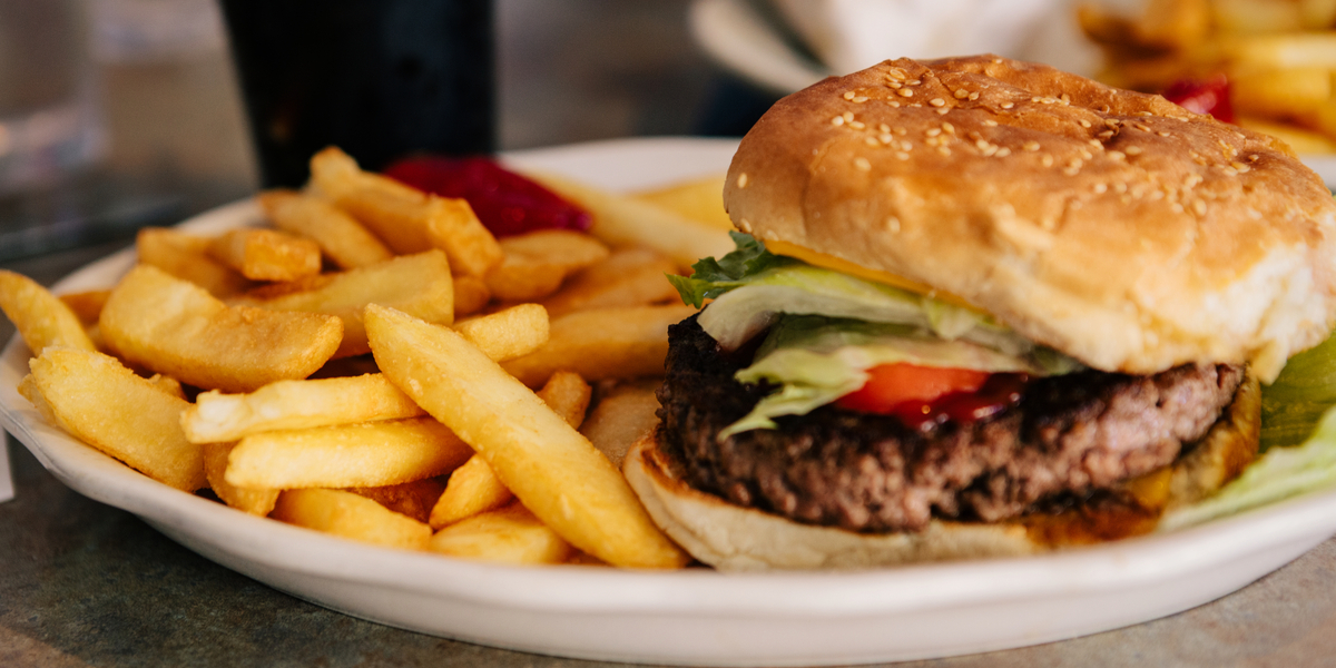 A plate of fries and a cheeseburger