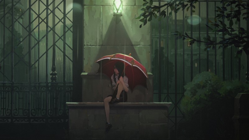 Caitlin sitting in the rain under an umbrella