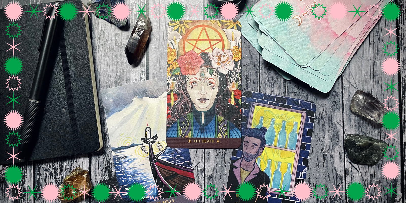 gorgeous tarot spread on a wood table, includes a notebook and pen, a tarot deck, multiple crystals, and three pulled cards: six of bells, death, and eight of vials