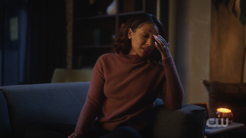 Iris West sitting on her couch staving off a wedding vows induced headache