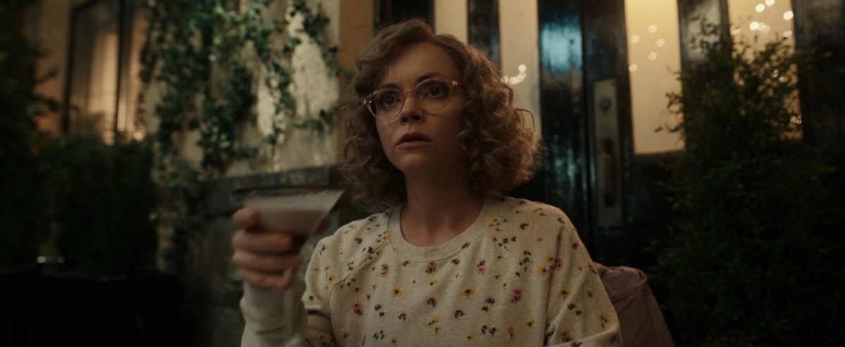 Yellowjackets 104 recap: A screenshot of Misty (Christina Ricci) holding a martini glass, wearing a floral pullover