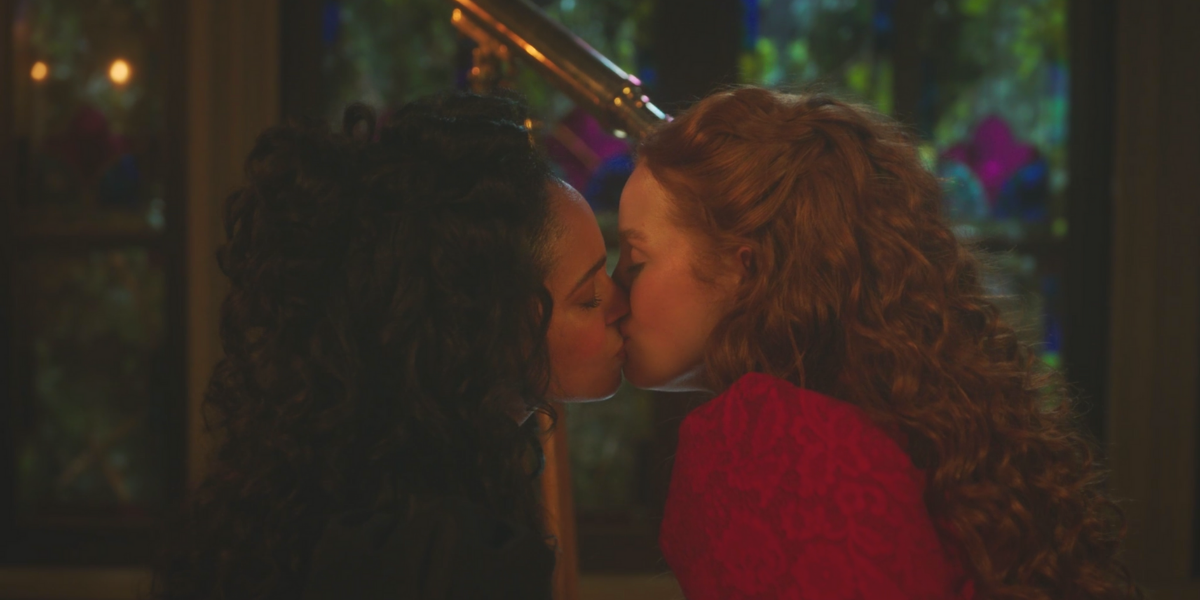 A photo of Thomasina Topaz and Abigail Blossom kissing in front of a telescope in 1892 in the Riverdale Sabrina crossover episode