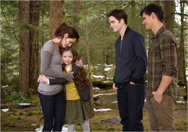 Bella hugs her chid in the woods while Jake and Edward are like "cool"