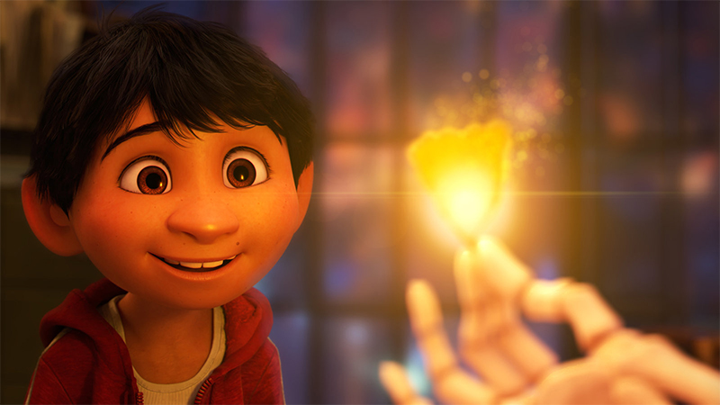 Miguel looks at a candle in Coco