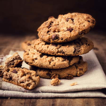 A stack of chocolate chip cookies on a cloth napkin