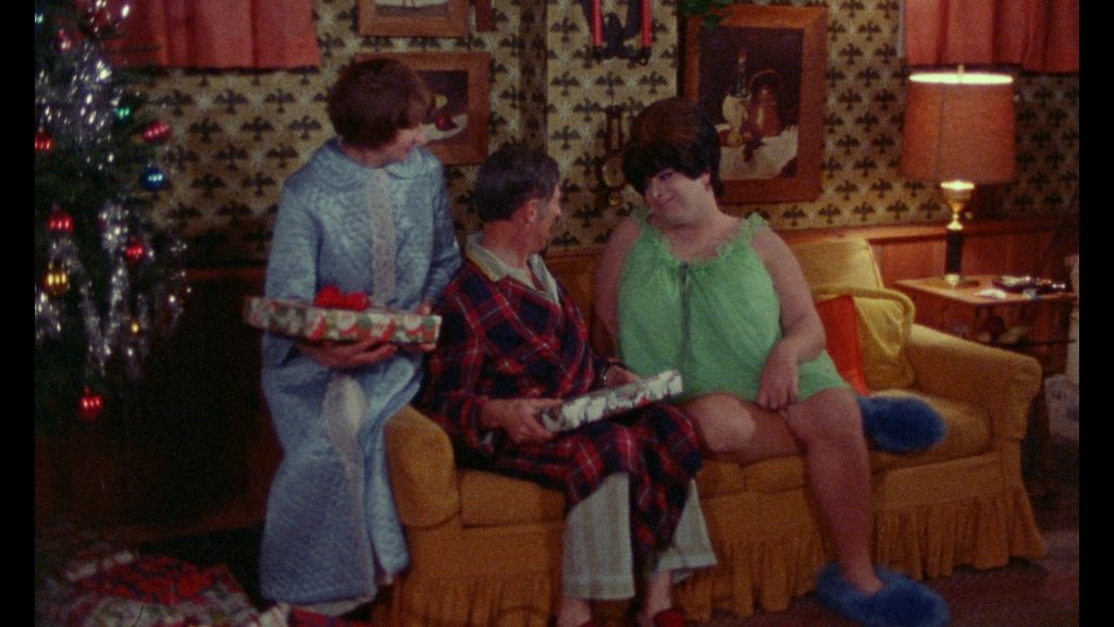still of characters on a couch by a Christmas tree in "Female Trouble"
