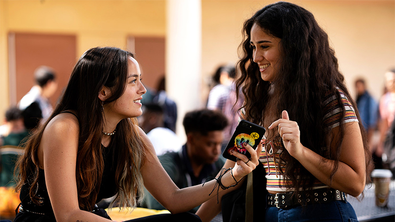 Greta and Riley smile at each other