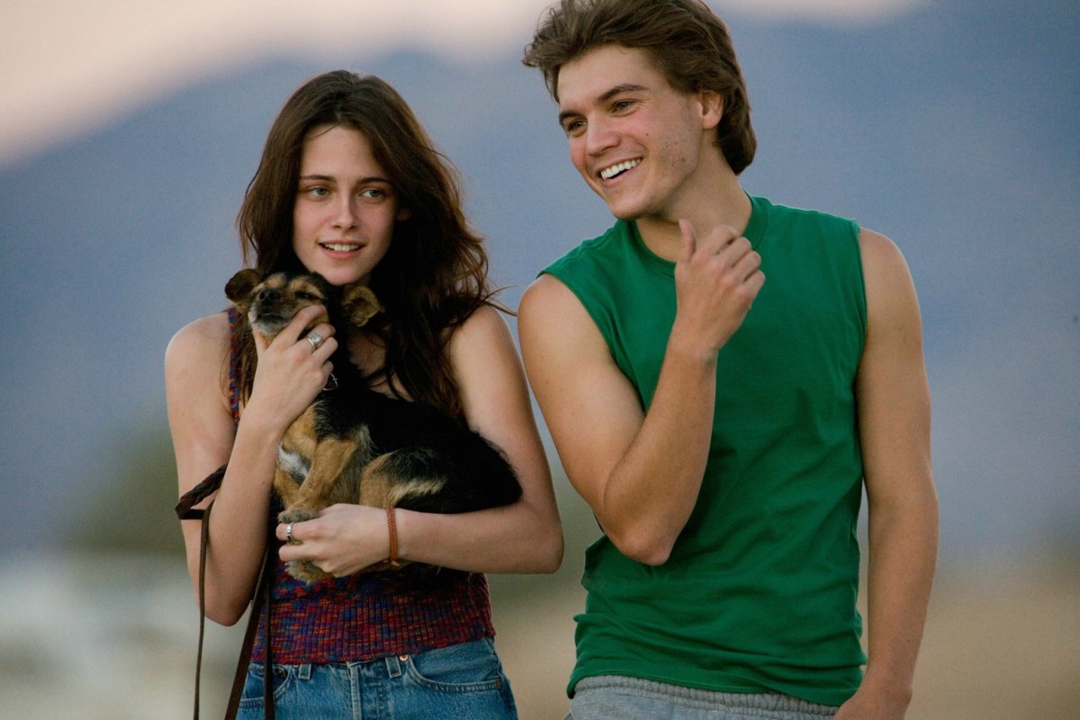 Into the Wild still, K-Stew is holding a dog