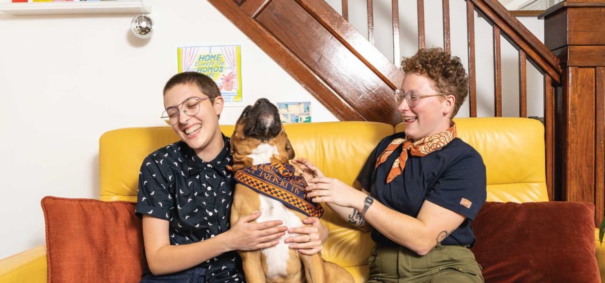 two queers playing with a dog in Peau De Loop apparel