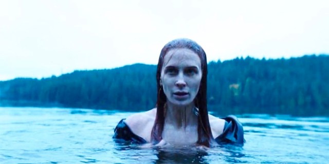 Bridget Regan as Poison Ivy pokes her head out of a lake