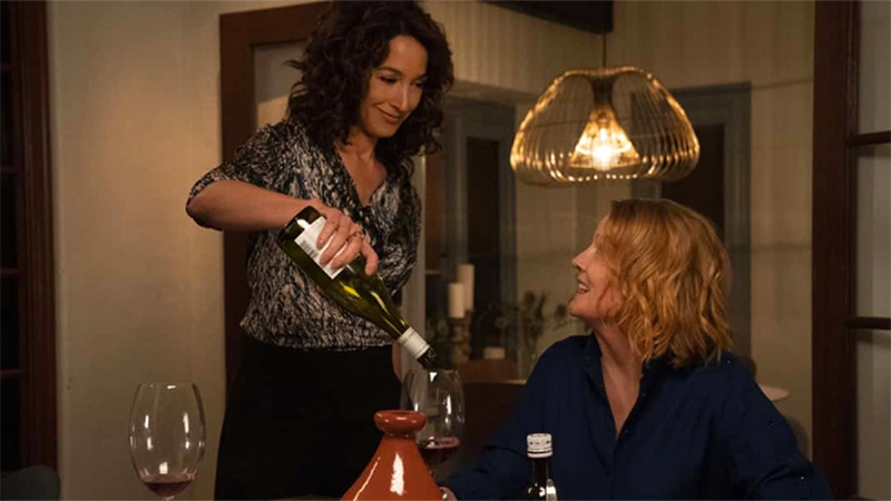 Bette pours Tina a glass of wine in The L Word: Generation Q