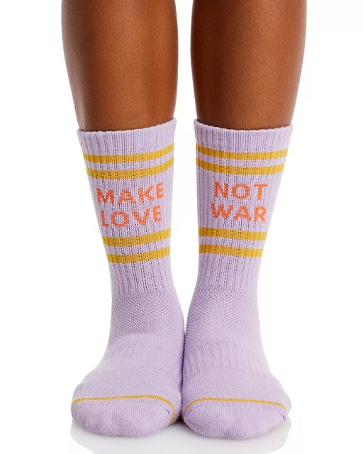 Purple socks say make love, not war in orange font