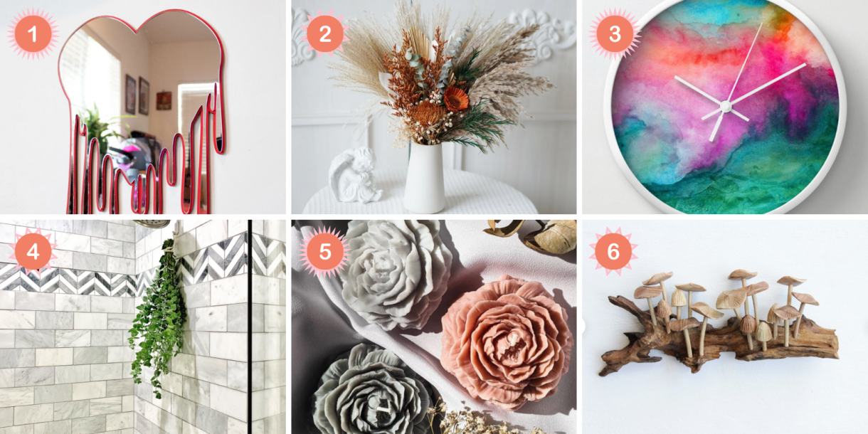 Photo 1: A red-rimmed mirror that is shaped like a heart that is dripping hangs on a white wall. Photo 2: A white vase holds a bouquet of orange, green, and brown dried flowers and sits on a white table. Photo 3: A clock whose face is watercolored blue, pink, purple, and green hangs on a white wall. Photo 4: A tied together bunch of eucalyptus hands under a shower head in a tiled showed. Photo 5: Dark gray, white gray, and pink candles shaped like flowers sit on a white cloth. Photo 6: A piece of art that looks like a chunk of wood with wooden mushrooms growing out of it hangs on a white wall
