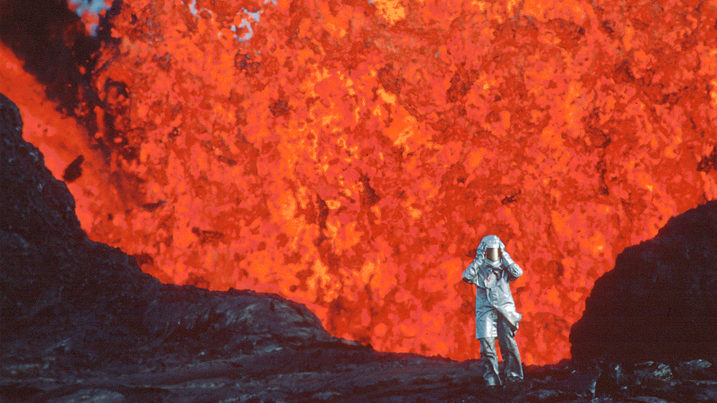 A person in a metal suit runs away from bright orange lava.
