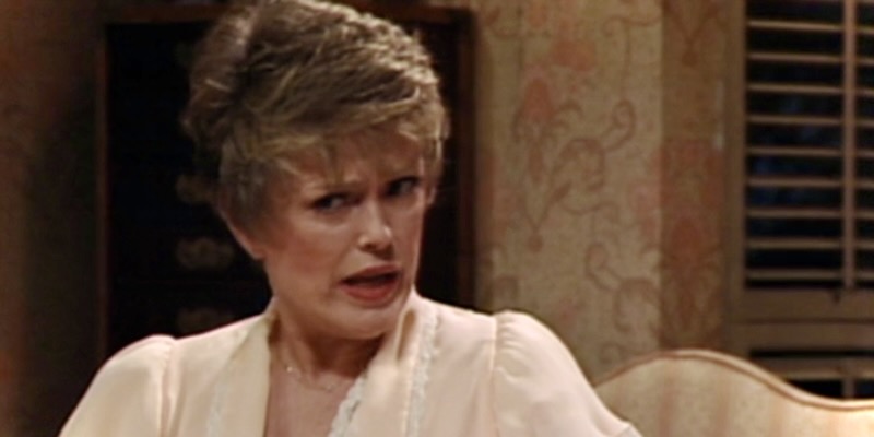 Blanche from Golden Girls has a confused look on her face, she is wearing a nightgown