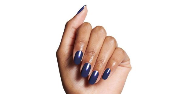 A black hand showcases navy blue nail polish from olve & jade