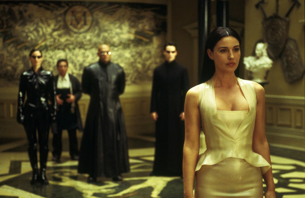 MONICA BELLUCCI with, in the background, (l-r:) CARRIE-ANNE MOSS, RANDALL DUK KIM, LAURENCE FISHBURNE and KEANU REEVES in Warner Bros. PicturesÕ and Village Roadshow PicturesÕ provocative futuristic action thriller "The Matrix Reloaded"