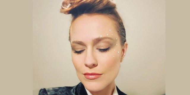 Evan Rachel Wood has her hair swept away from her face and shimmery glittery eye make up