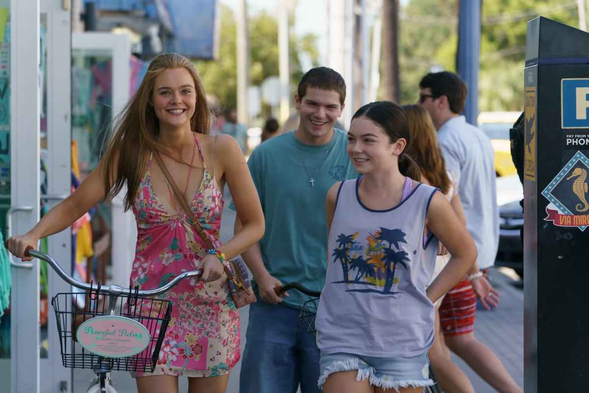 Girl From Plainville still: Michelle in a sundress with her bicycle, friend in a tank top and boy behind her