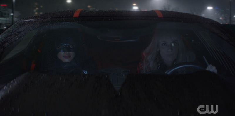 Alice driving the Batmobile and Ryan in the passenger seat