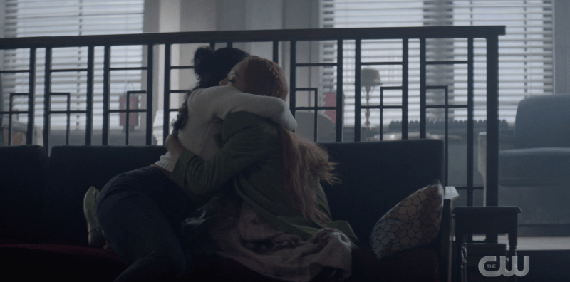 Ryan and Mary hugging while sitting on the couch at The Hold Up