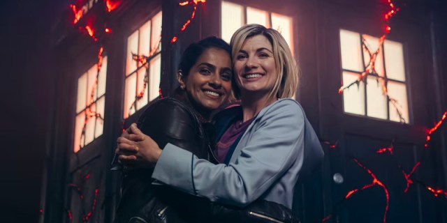 The Doctor and Yaz hug in front of the TARDIS