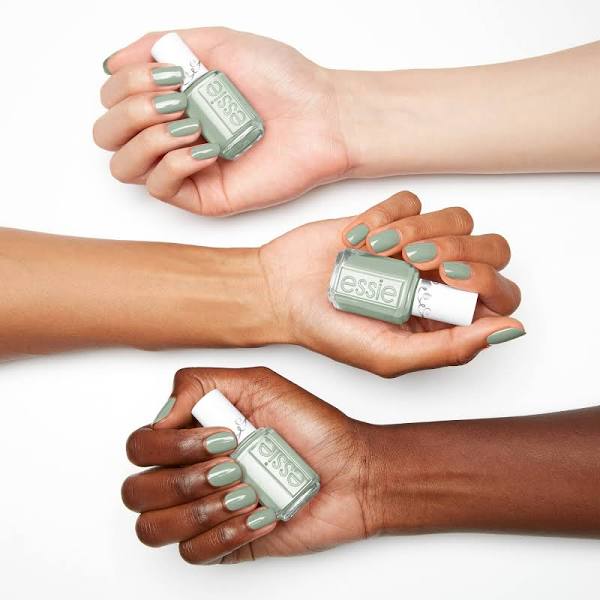 A variety of skin tones holding sage green nail polish from Essie