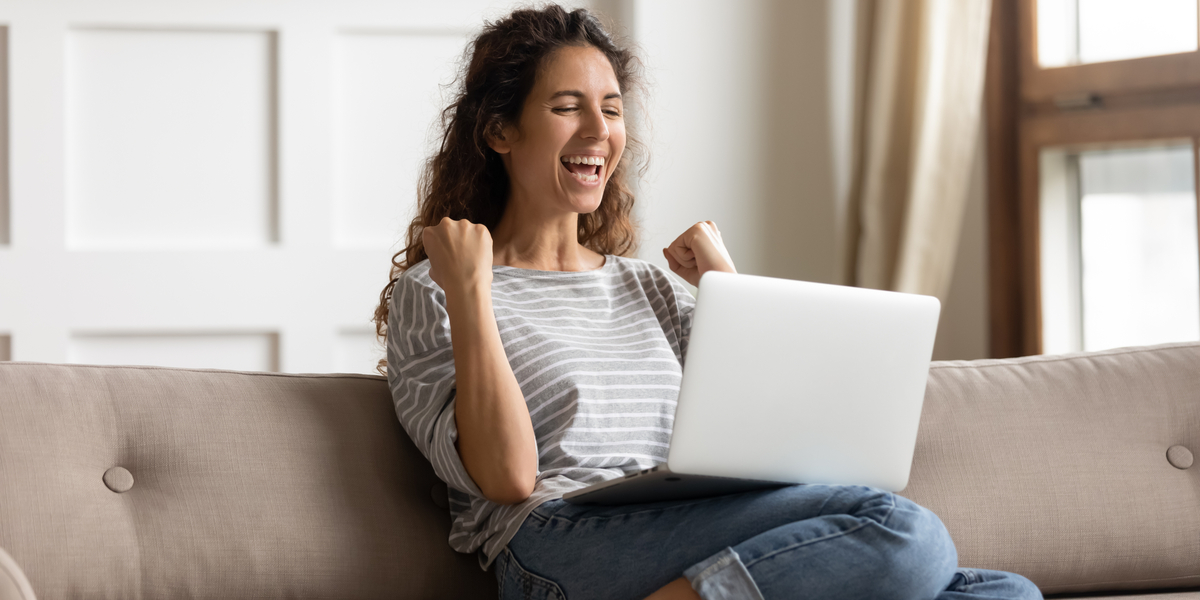 girl excited to be reading her laptop