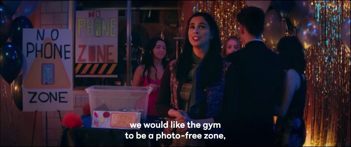 Parker at the school dance announcing that it is a photo-free zone