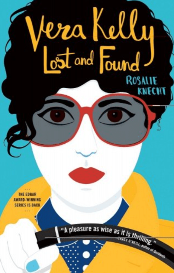 The cover of Vera Kelly Lost and Found by Rosalie Knecht. This cover has an illustration of a woman on the cover in bold primary colors. The skin is snow white, lips bright red, hair black, sunglasses red-framed, there is a bright jacket and she is holding a steering wheel, so presumably, driving.
