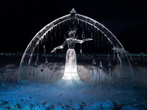 an ice sculpture showing a woman under an arch surrounded by mushrooms