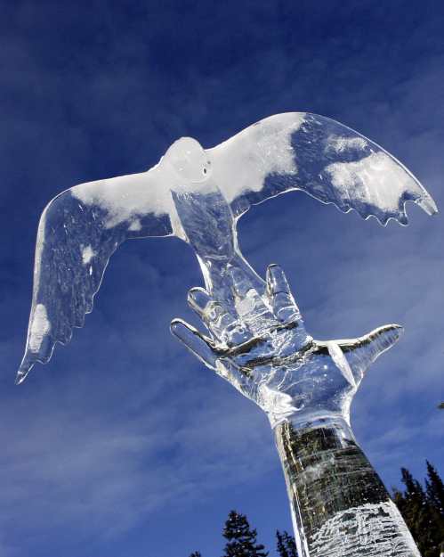 ice sculpture of a bird taking off from a hand