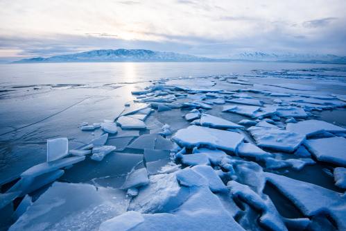 an icy lake where the ice has started breaking up