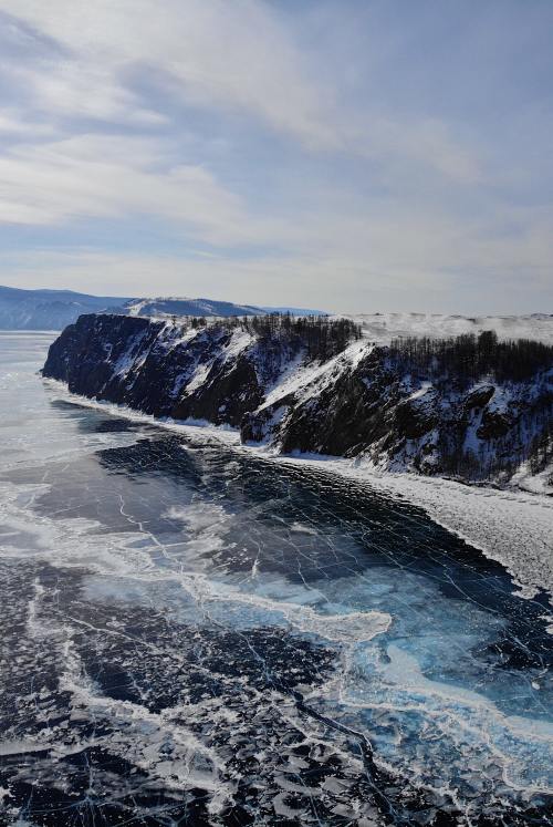 an icy lake that juts up against mountains