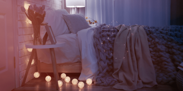 gorgeous clean cozy bedroom with fairy lights and a comfortable bed