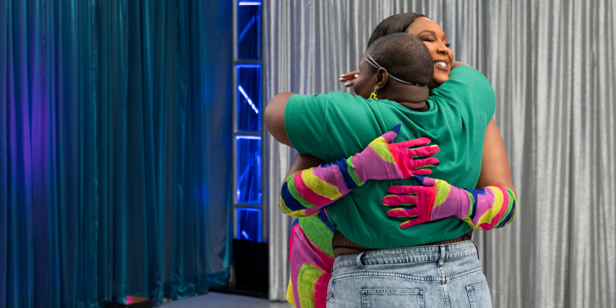 Lizzo smilng and hugging one of the potential dancers