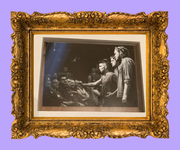 a photo of Ro aggressively gifting an audience member a PJ Harvey mix CD. The photo is black and white. It is within a golden frame design