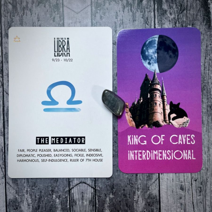 The King of Caves is a blue and purple card with a moon and a castle, the next card says Libra is The Mediator