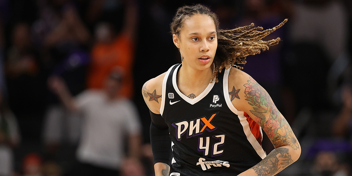 Brittney Griner in a black Phoenix Mercury jersey running on court