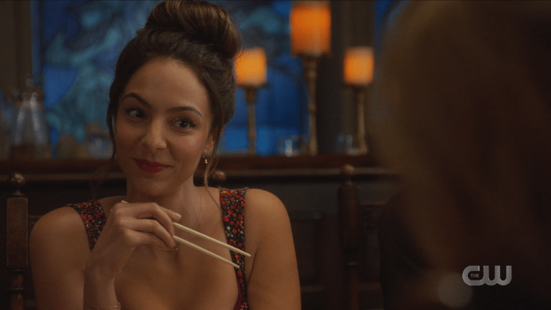 Zari smiles with chopsticks in her hand