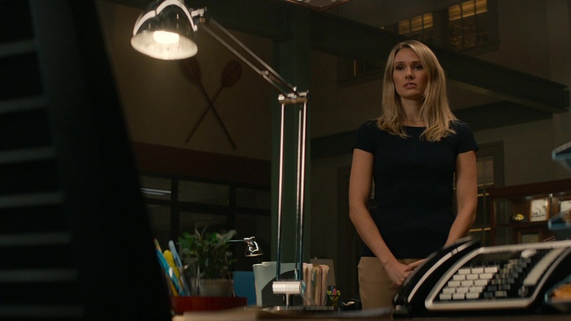 Kate Whistler looks sadly at her ex-girlfriend's empty desk at NCIS HQ.