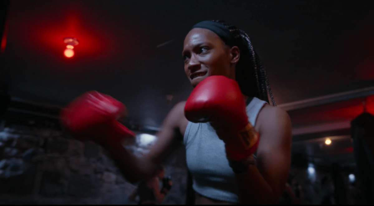 Jojo T. Gibbs wearing a headband and a gray tanktop and boxing gloves while boxing in the movie Fresh