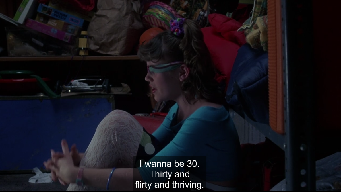 Young Jenna Rink is blindfolded in her closet and says "I wanna be 30. Thirty and flirty and thriving."